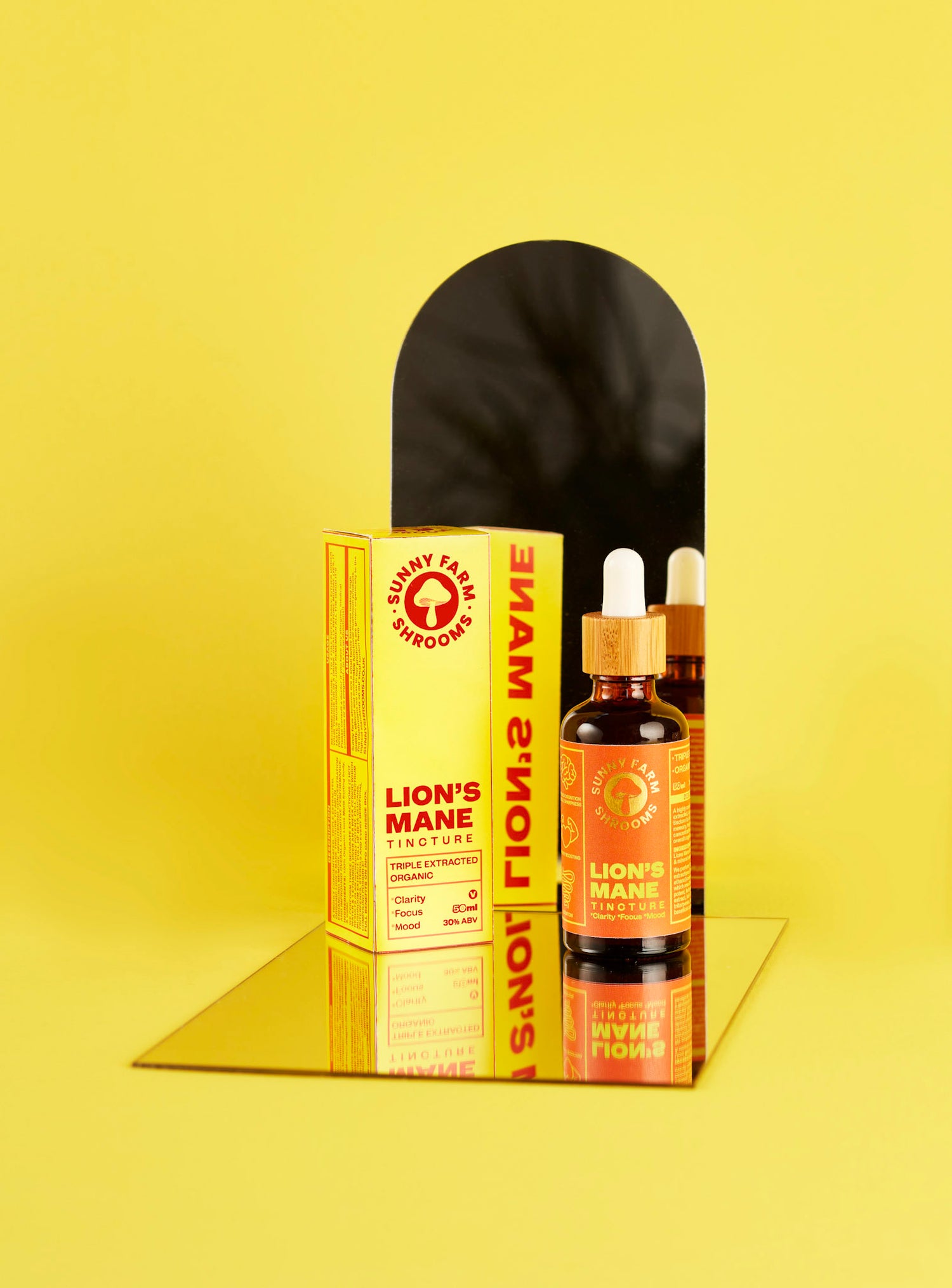 A bottle of lion's mane tincture in front of a mirror